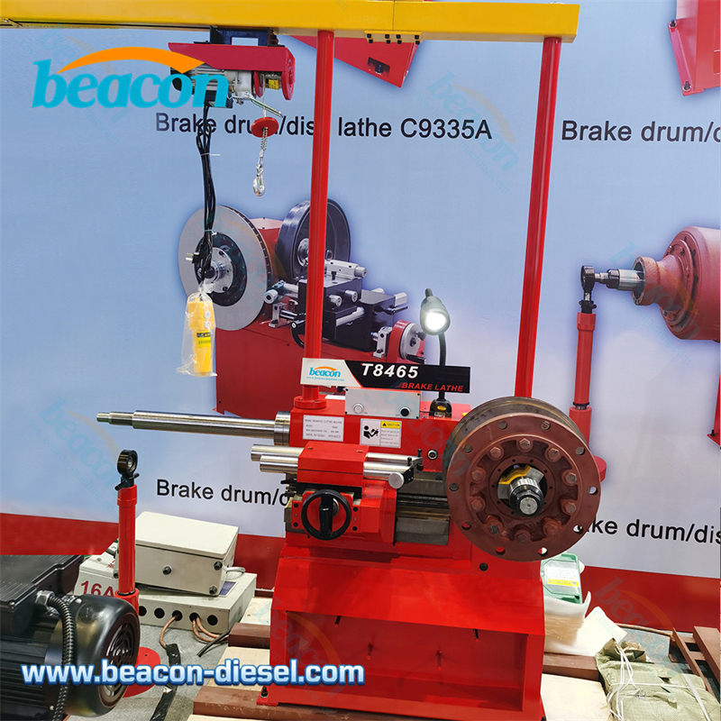 Beacon T8465 heavy duty brake lathe front view with electric hoist red machine body