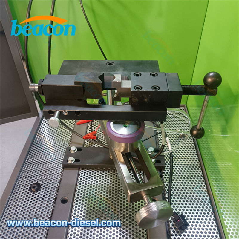 Illuminated injector testing chamber with protective glass